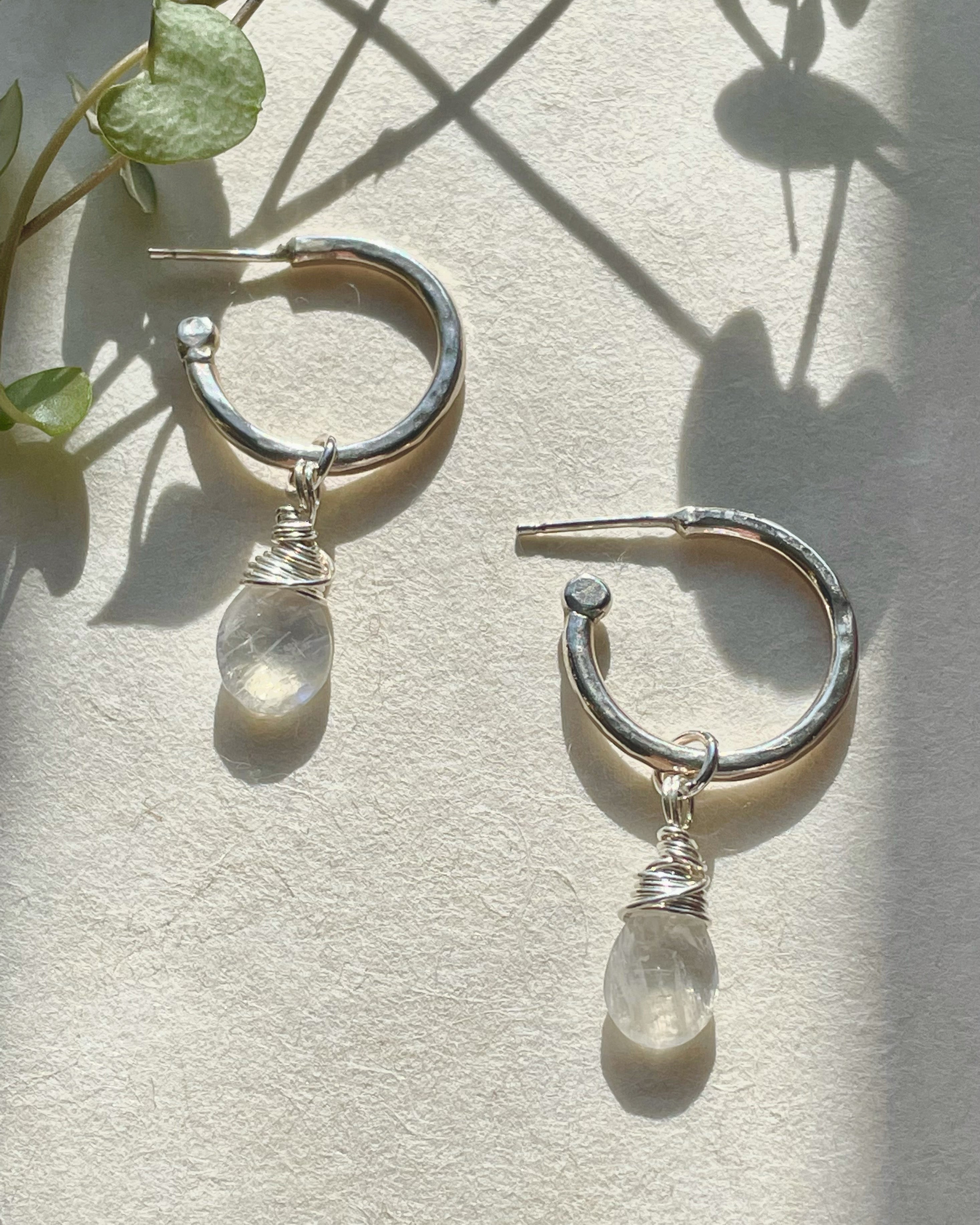 Mystic moonstone briolettes sparkle inside shiny sterling silver hoop earrings on custom ear wires. Mystic moonstone outlet takes on colors near by